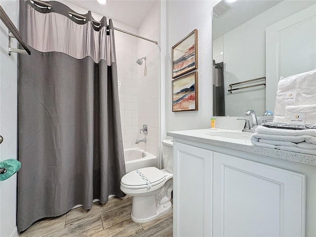 full bathroom featuring vanity, hardwood / wood-style floors, toilet, and shower / bath combo