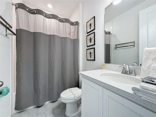 bathroom with tile patterned flooring, vanity, and toilet