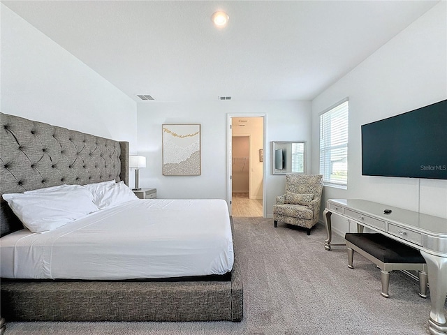 bedroom featuring carpet and ensuite bath