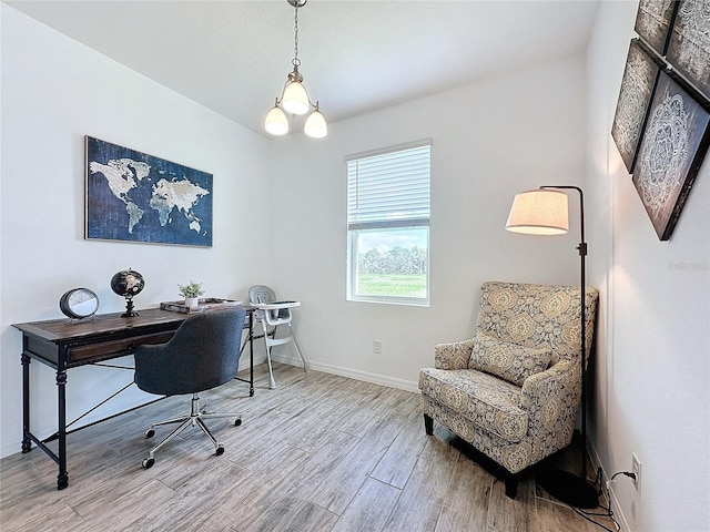 office space featuring a notable chandelier and light wood-type flooring