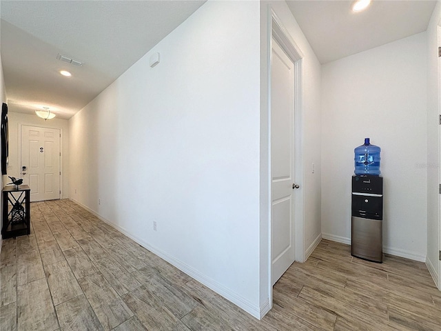 hallway with light hardwood / wood-style floors