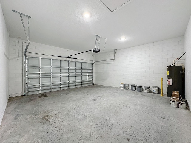 garage featuring water heater and a garage door opener