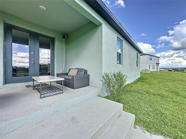 view of home's exterior featuring a lawn, french doors, and a patio area