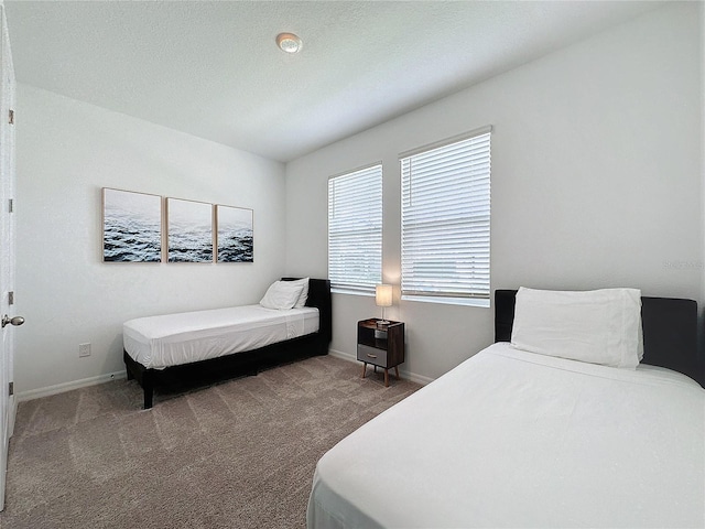 carpeted bedroom featuring a textured ceiling