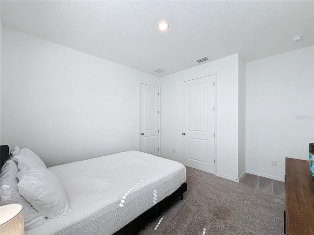 carpeted bedroom with a textured ceiling