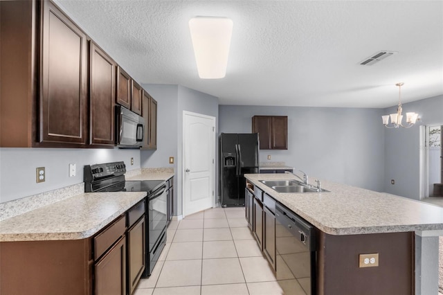 kitchen with pendant lighting, sink, a kitchen island with sink, dark brown cabinets, and black appliances