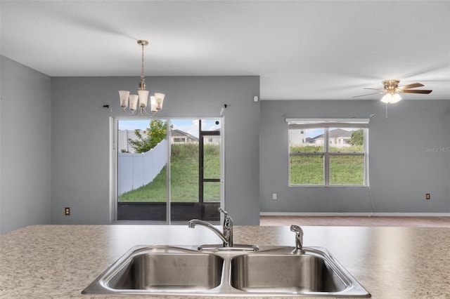 kitchen featuring sink, a wealth of natural light, a chandelier, and decorative light fixtures