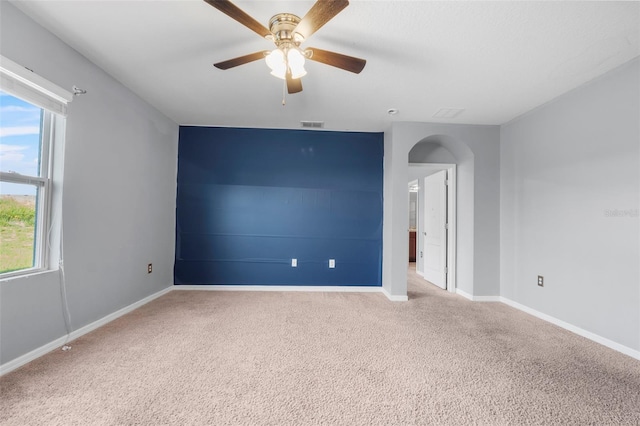 spare room with light carpet and ceiling fan