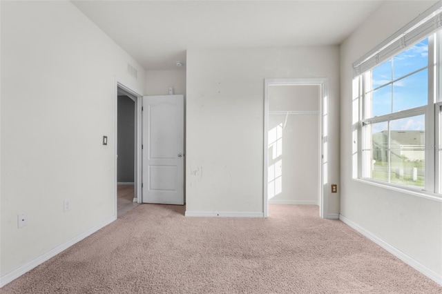 carpeted spare room with a healthy amount of sunlight