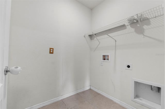 washroom with electric dryer hookup, washer hookup, and light tile patterned floors