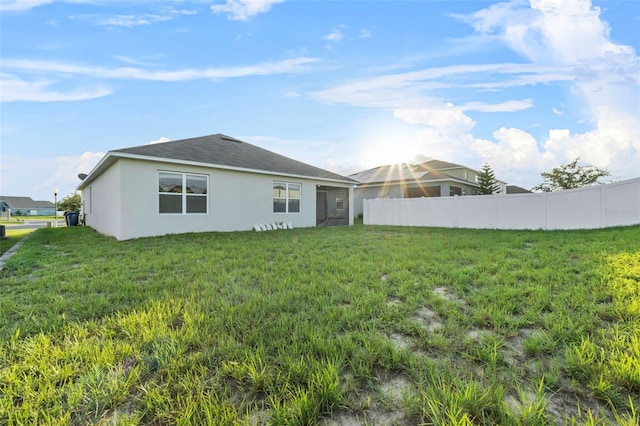 rear view of house with a lawn