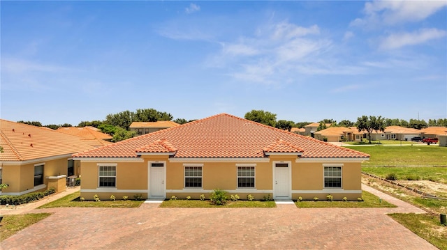 mediterranean / spanish-style home with a front lawn