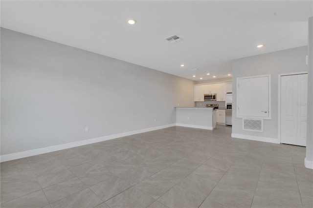 unfurnished living room with light tile patterned flooring