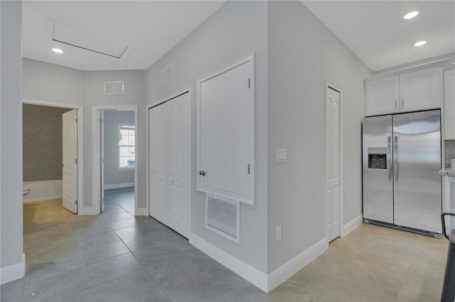 hall featuring light tile patterned floors