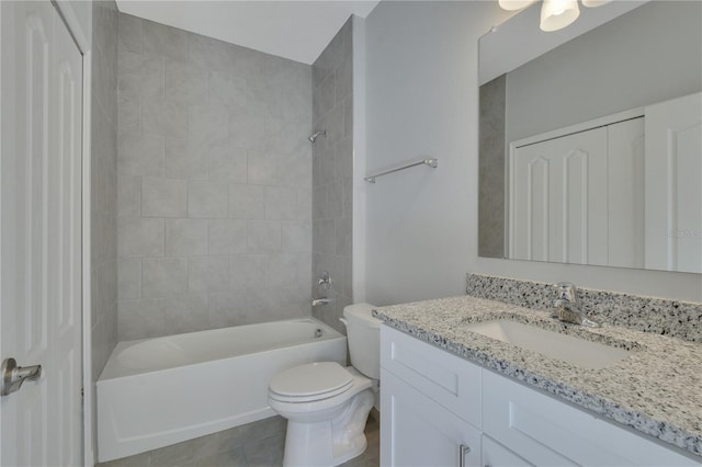 full bathroom with vanity, tiled shower / bath combo, toilet, and tile patterned floors