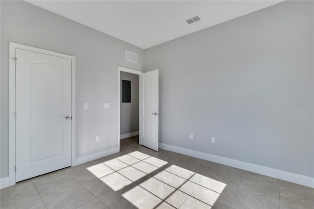 unfurnished bedroom featuring electric panel and light tile patterned floors