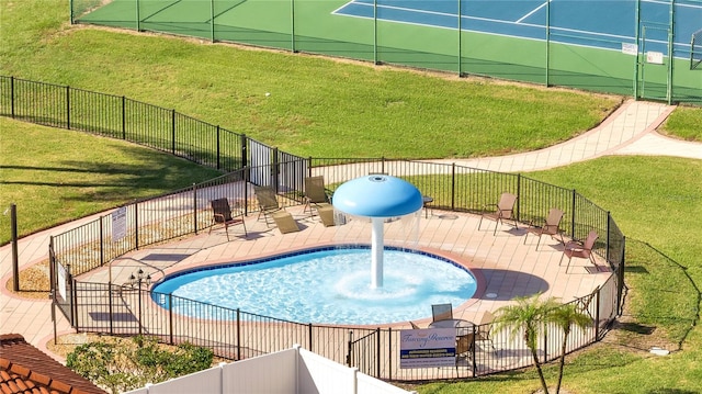 view of swimming pool featuring a lawn and a patio area