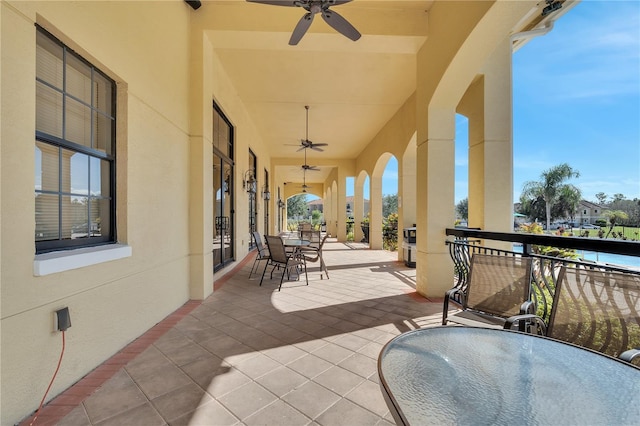 view of patio / terrace featuring ceiling fan and a balcony