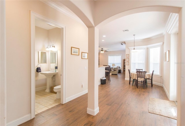 interior space featuring wood-type flooring and ornamental molding