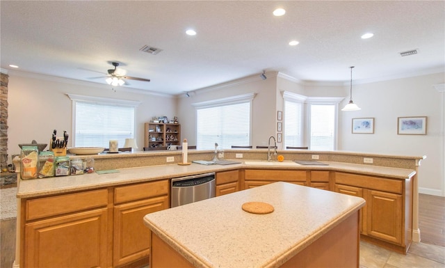 kitchen with stainless steel dishwasher, ornamental molding, ceiling fan, decorative light fixtures, and an island with sink