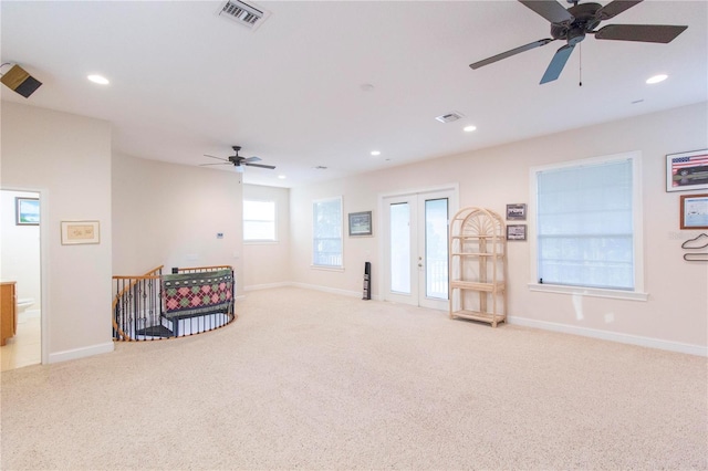 sitting room featuring light carpet and ceiling fan