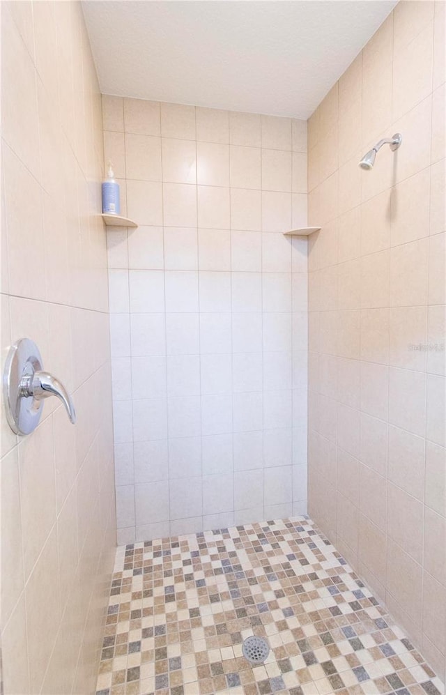 bathroom with tiled shower