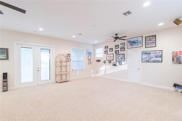 interior space featuring ceiling fan, light carpet, and french doors