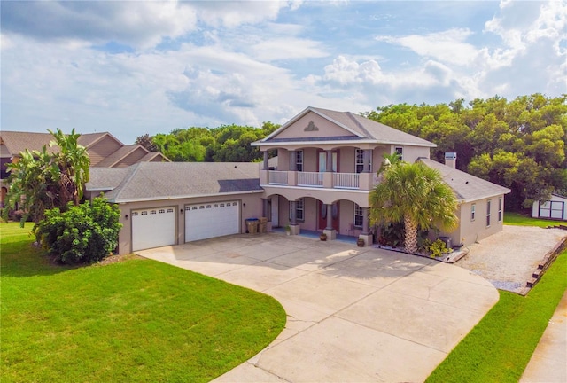 view of front of property with a porch, a balcony, a front yard, and a garage