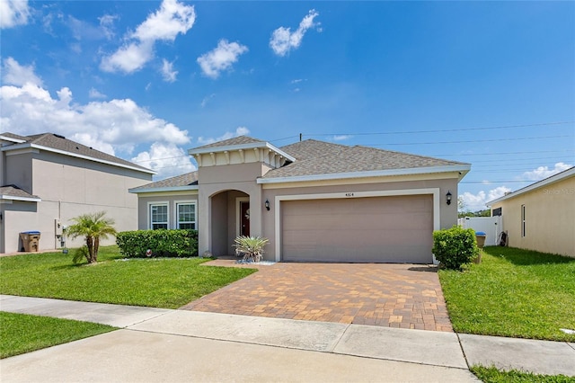 view of front of property with a garage and a front lawn