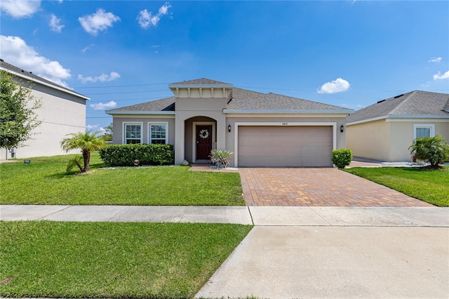 view of front facade with a front yard and a garage