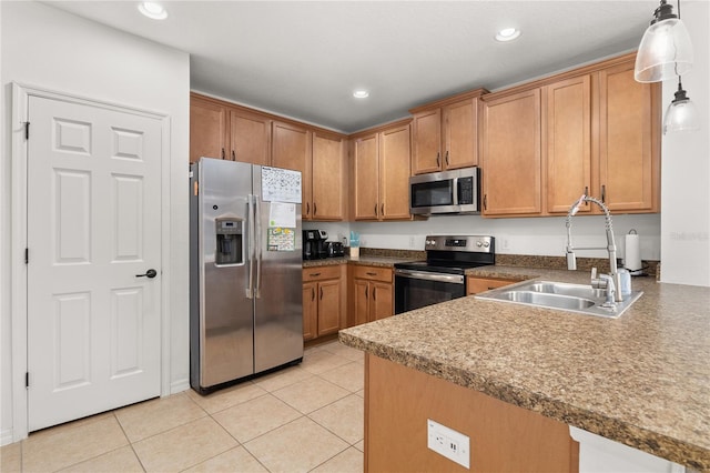 kitchen featuring light tile patterned flooring, appliances with stainless steel finishes, hanging light fixtures, and sink