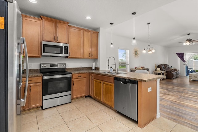 kitchen with a healthy amount of sunlight, sink, ceiling fan, and stainless steel appliances