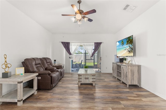 living room with ceiling fan and dark hardwood / wood-style flooring