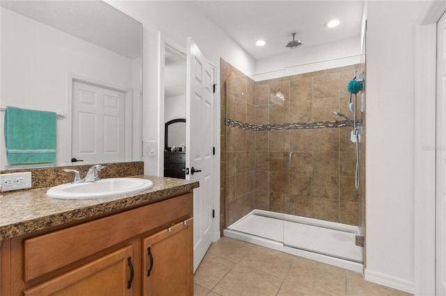 bathroom featuring vanity, tile patterned floors, and a shower with door