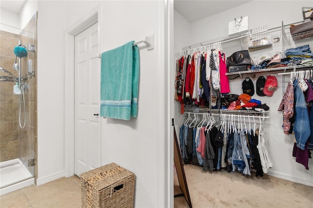 walk in closet with tile patterned floors