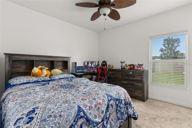 carpeted bedroom featuring ceiling fan and multiple windows