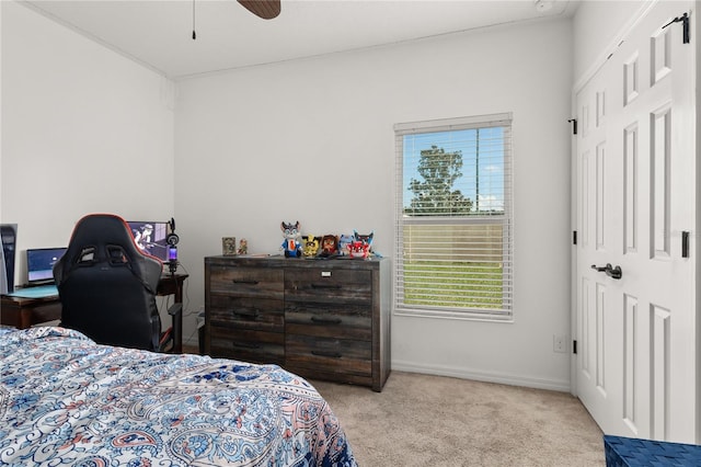 carpeted bedroom with ceiling fan and a closet