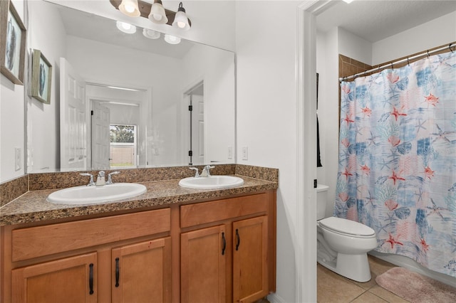 bathroom featuring a shower with curtain, vanity, toilet, and tile patterned floors