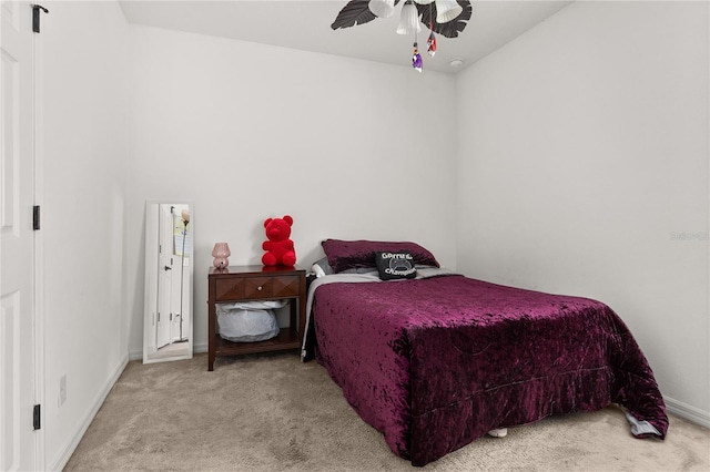 bedroom with light carpet and ceiling fan