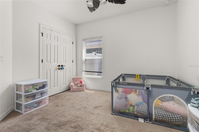 rec room with carpet flooring and ceiling fan