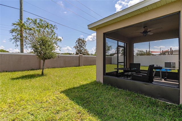 view of yard with central AC, ceiling fan, and a patio area