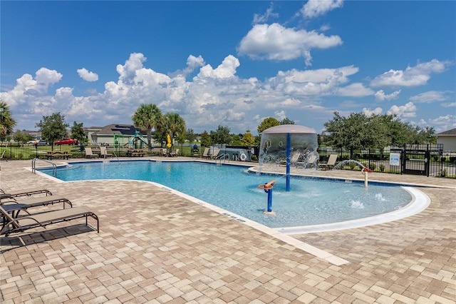 view of swimming pool featuring pool water feature and a patio area