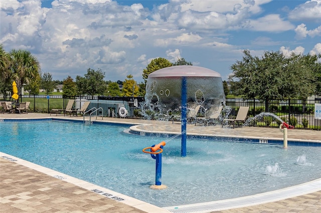 view of swimming pool featuring pool water feature and a patio area