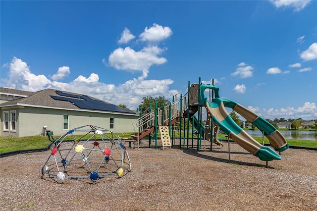 view of playground with a water view