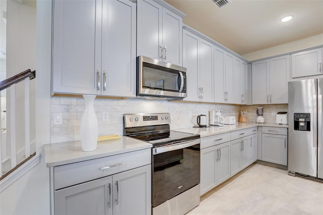 1842 Tropical Palms Cir, Kissimmee, FL 34747 - kitchen with appliances with stainless steel finishes, light countertops, backsplash, and recessed lighting