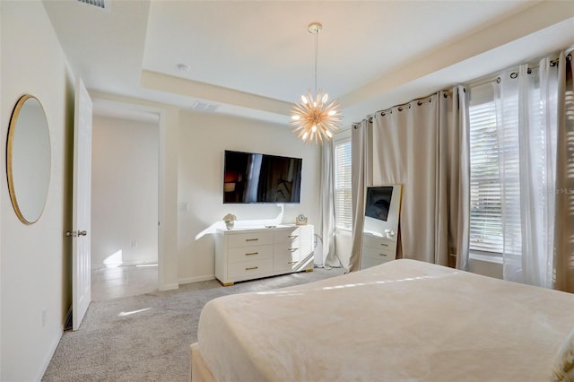 carpeted bedroom with a notable chandelier and multiple windows