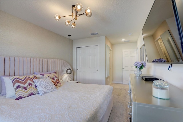 carpeted bedroom with a notable chandelier and a closet