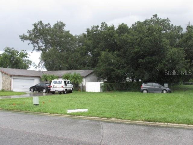 view of front of home with a front yard and a garage