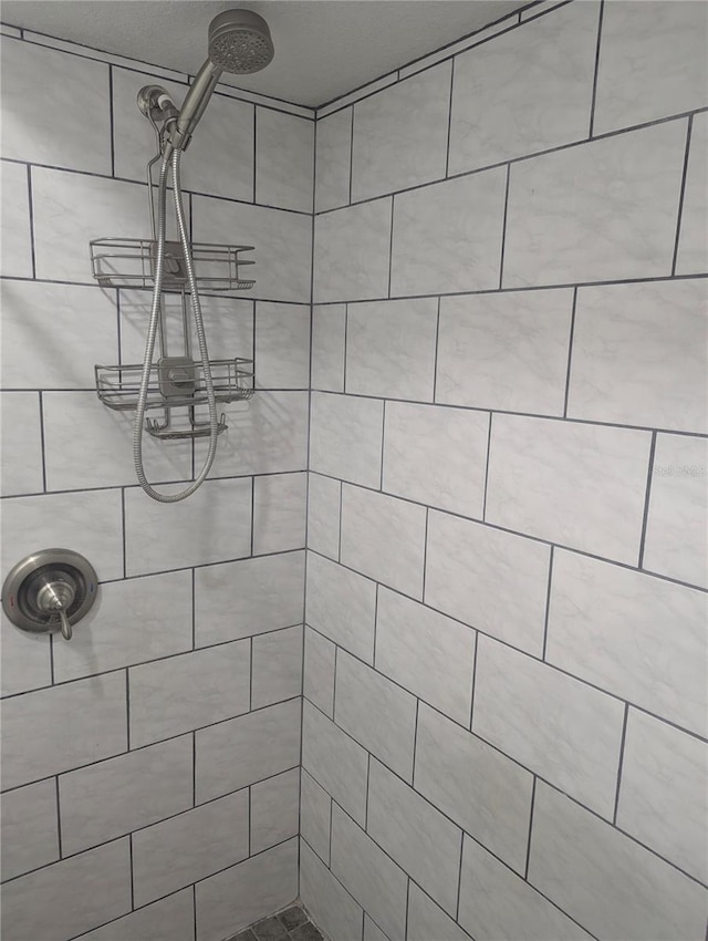 bathroom with tiled shower