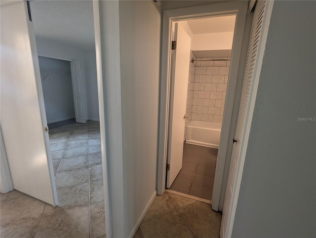 hallway featuring light tile patterned floors